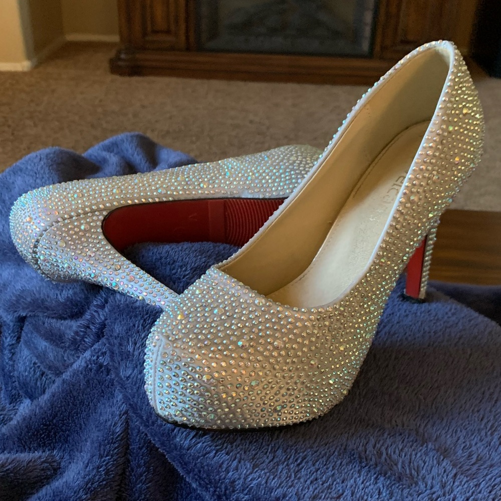 Rhinestone platform pump with red bottoms.
